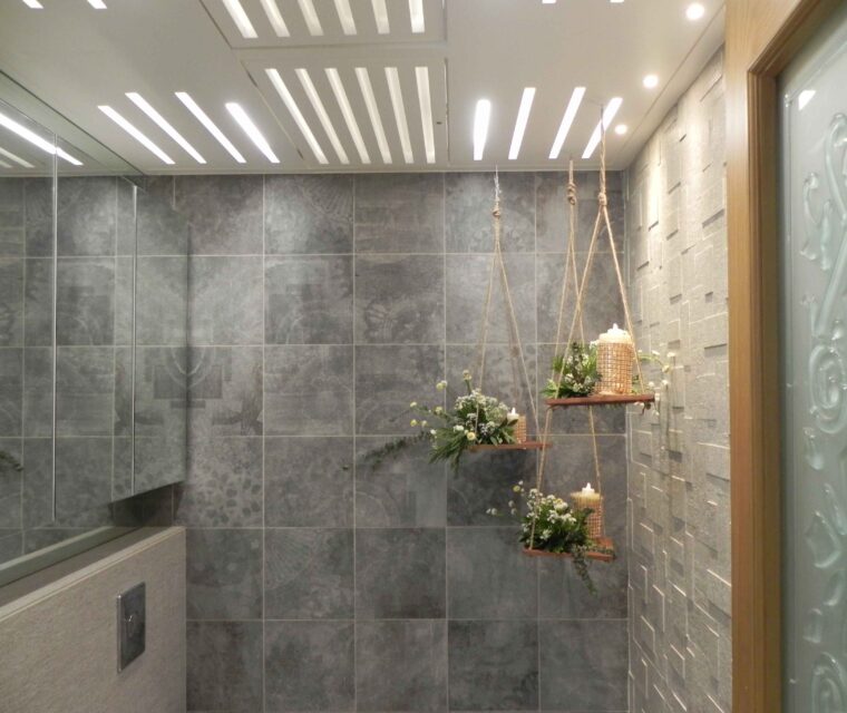 Elegant bathroom with grey tiles and hanging floral decor, luxury interiors