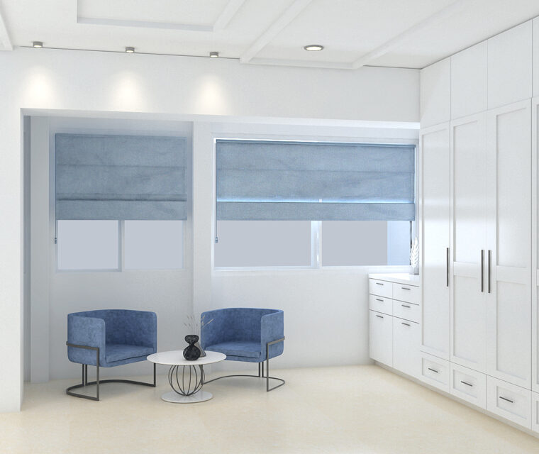 Elegant walk-in wardrobe area with blue accent chairs, white cabinetry, and natural light