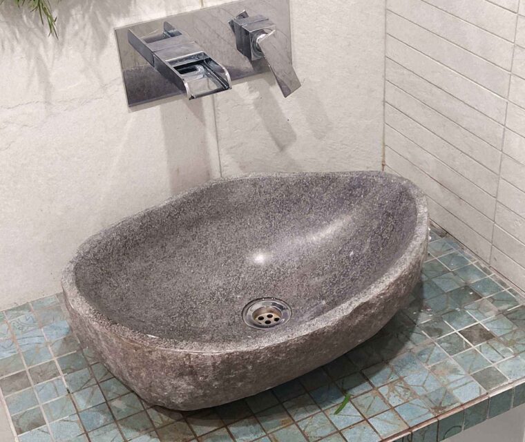 Designer bathroom wash basin with floral decor and stone counter