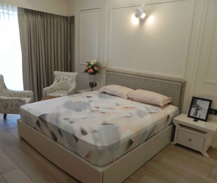 Elegant bedroom seating area with upholstered floral armchairs