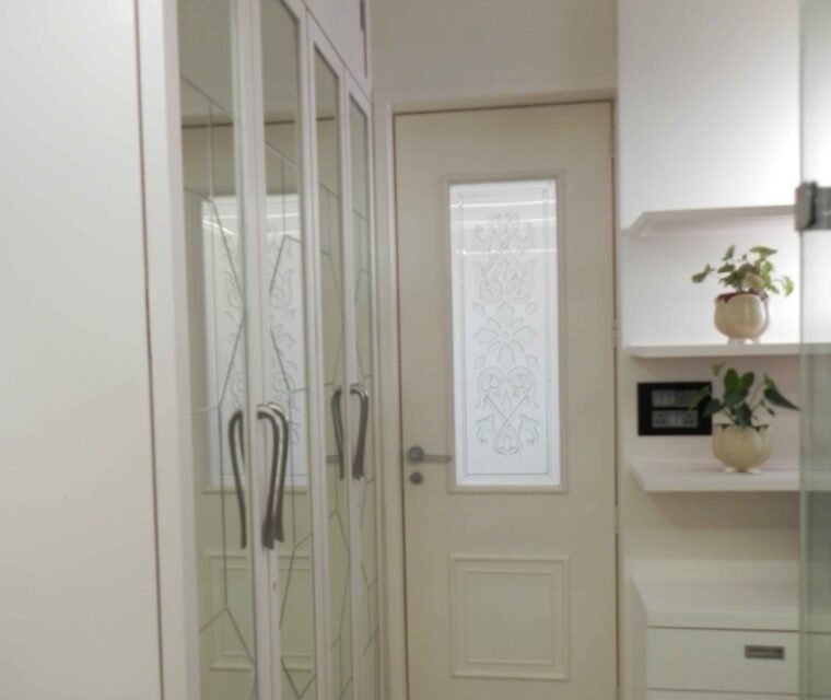 White wardrobe with mirrored panels in modern bedroom interior design