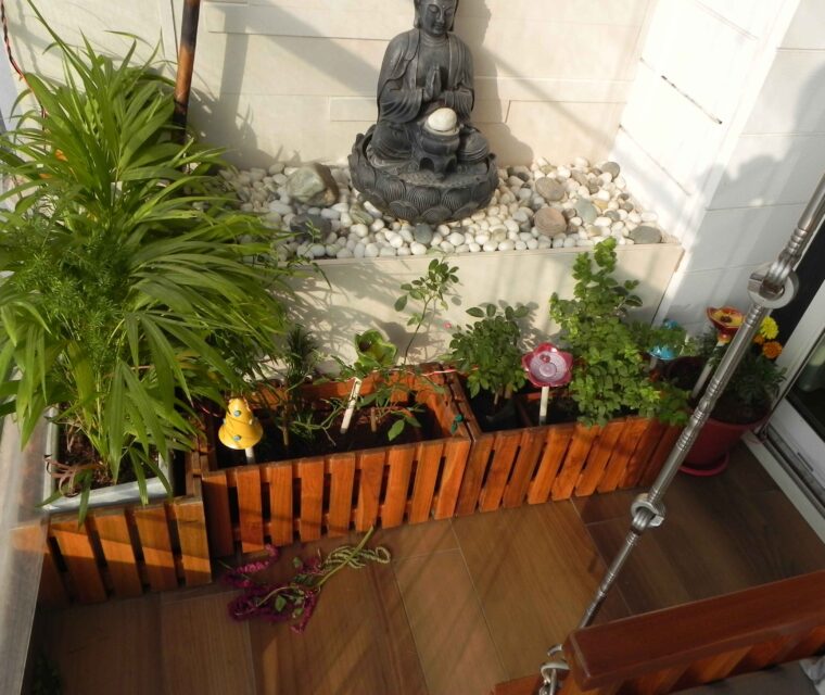 Balcony garden with Buddha statue and lush green plants for serene home decor