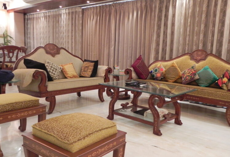 Contemporary kitchen with modular storage, black countertop, and abstract wall tiles