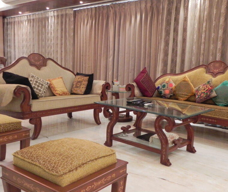 Contemporary kitchen with modular storage, black countertop, and abstract wall tiles