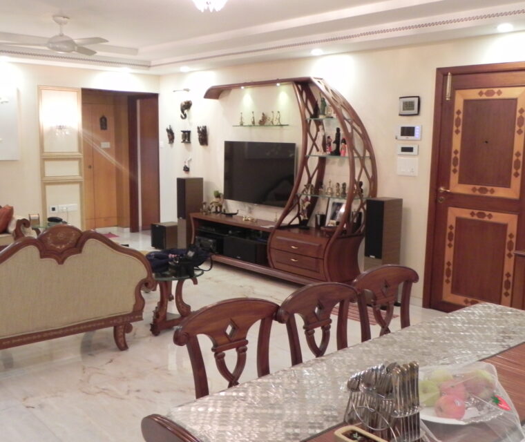 Elegant living room with carved wooden furniture and showcase unit