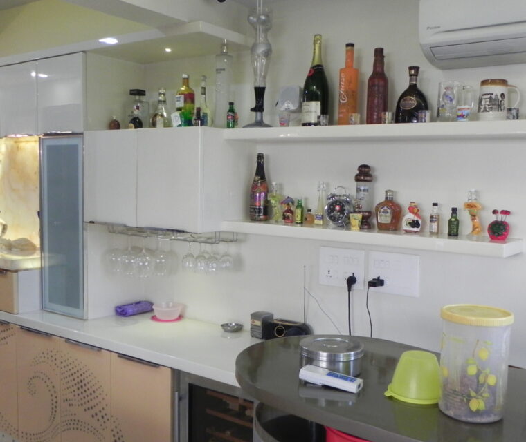 Modern open bar counter with glass shelves and home bar setup