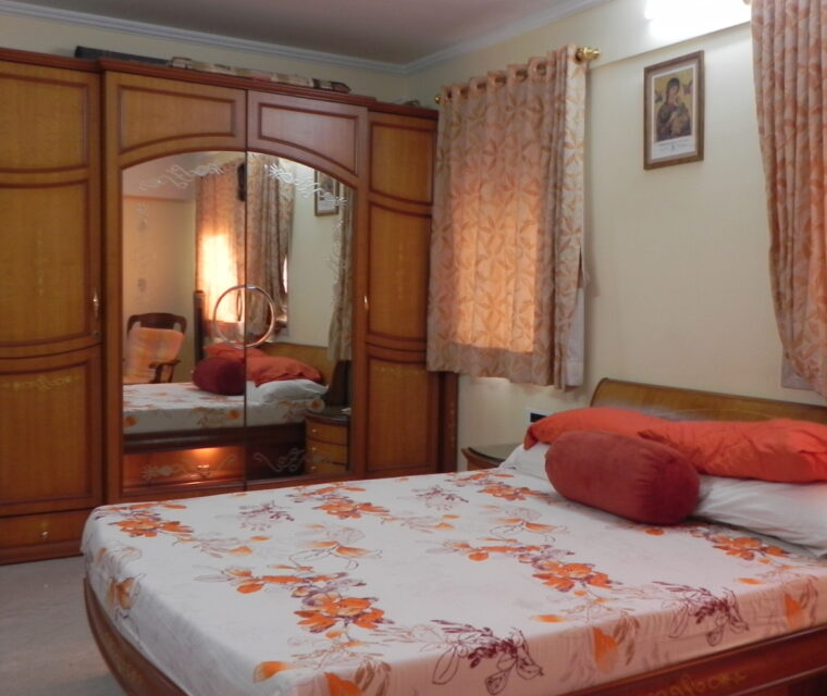 Classic wardrobe design with mirror and wooden finish in master bedroom