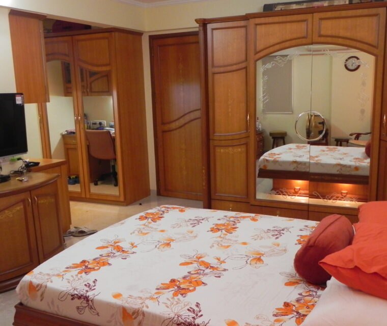 Classic wardrobe design with mirror and wooden finish in master bedroom