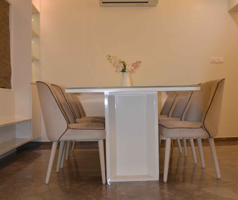 Modern dining area with beige chairs and white table in luxury apartment interior design