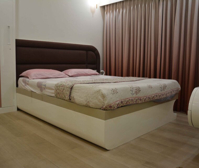 Contemporary bedroom with padded headboard and pastel decor in stylish home interiors