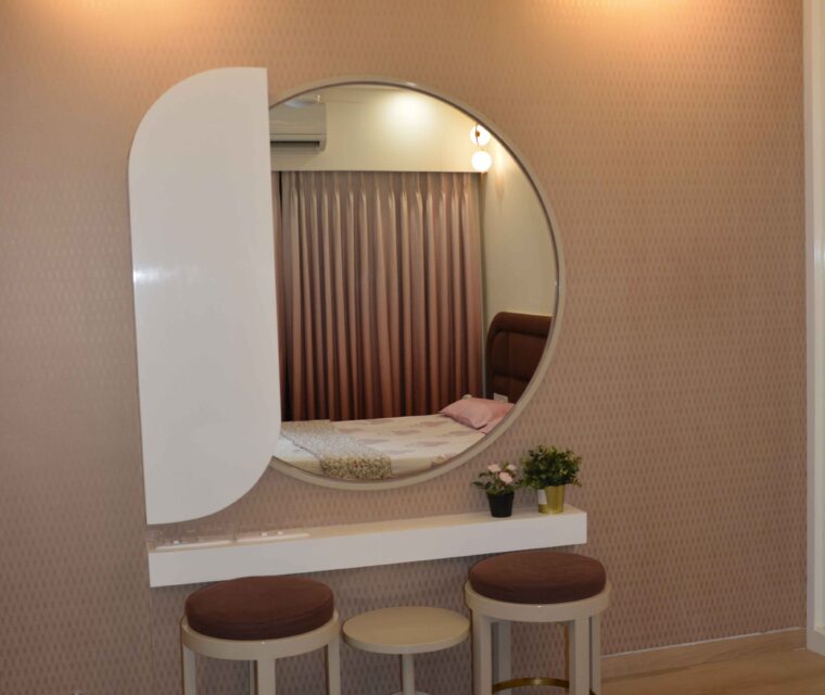 Elegant bedroom dressing table with large round mirror and stylish stools