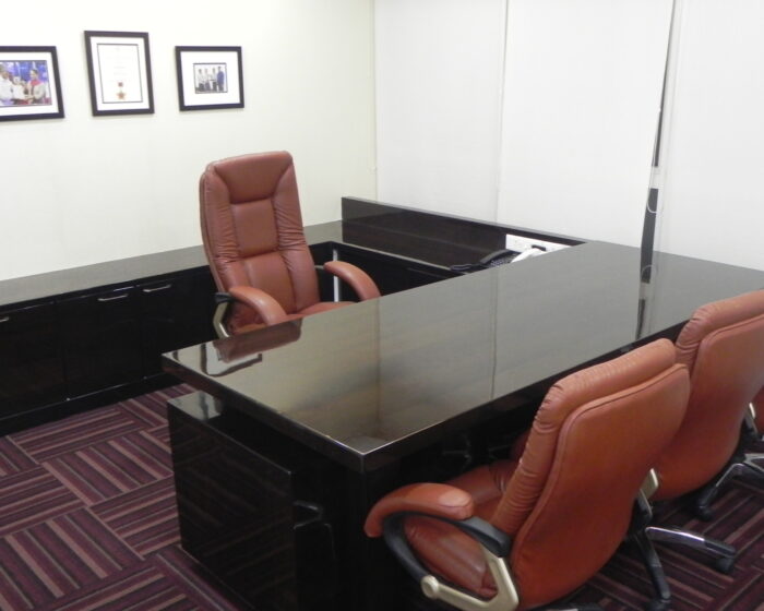 Modern executive office interior design with ergonomic leather chairs and glossy conference table