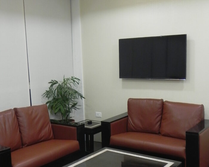 Elegant office lounge interior with leather sofas and smart TV for corporate workspace relaxation