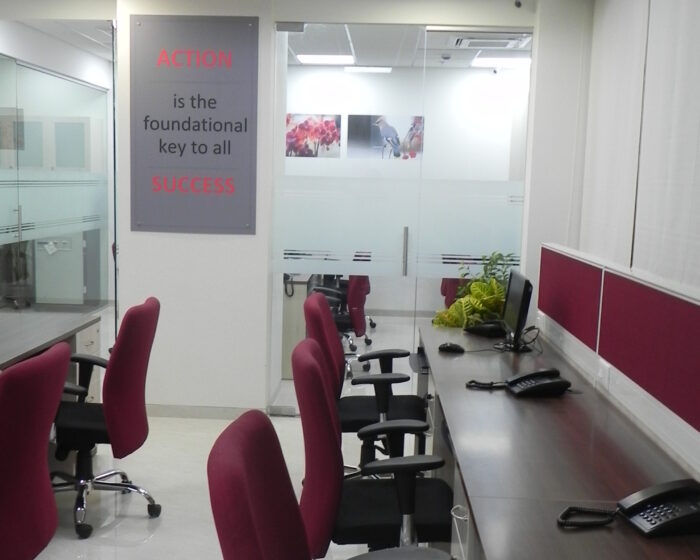 Open office layout with collaborative workstations and telephones