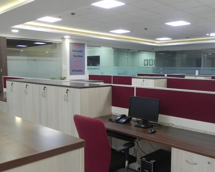 Modern office workspace interior with computer workstations and ample storage cabinets