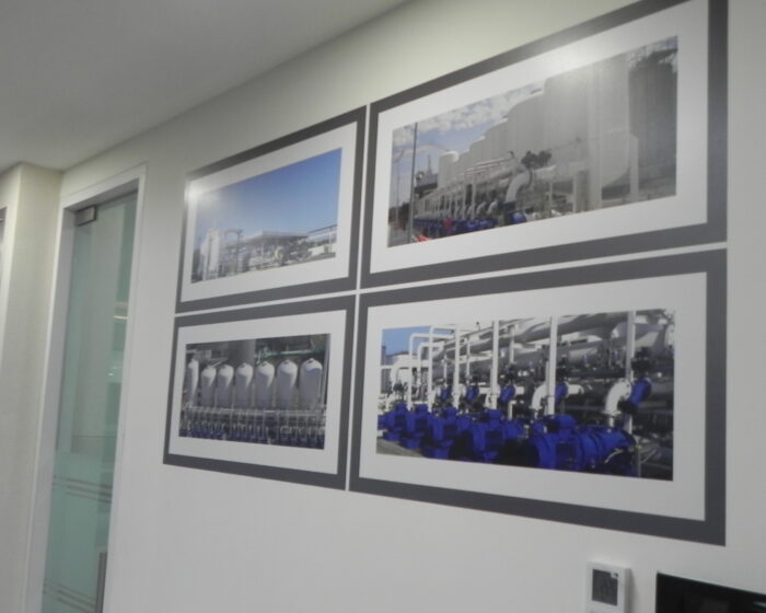 Office corridor wall decor with industrial project photo frames and motivational signage