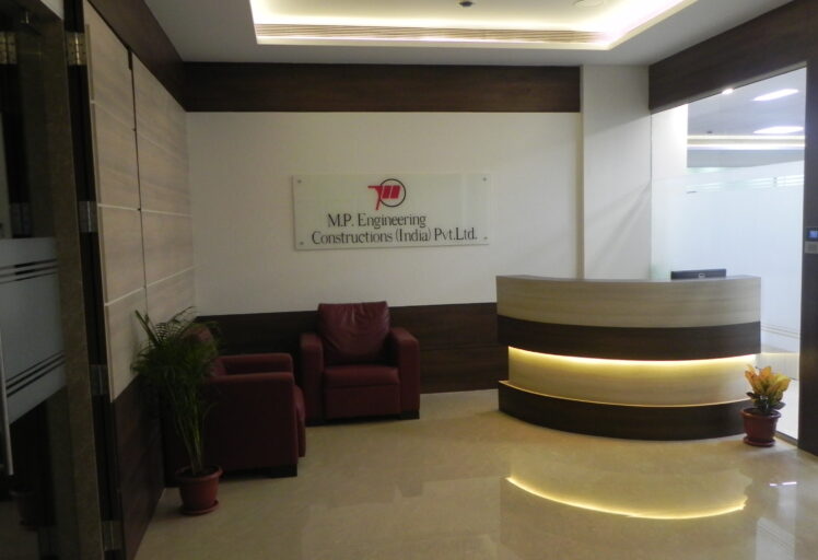 Stylish reception area interior at M.P. Engineering office with branded logo and designer lighting