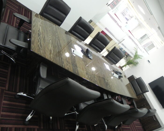 Stylish corporate meeting room interior with large conference table and executive chairs