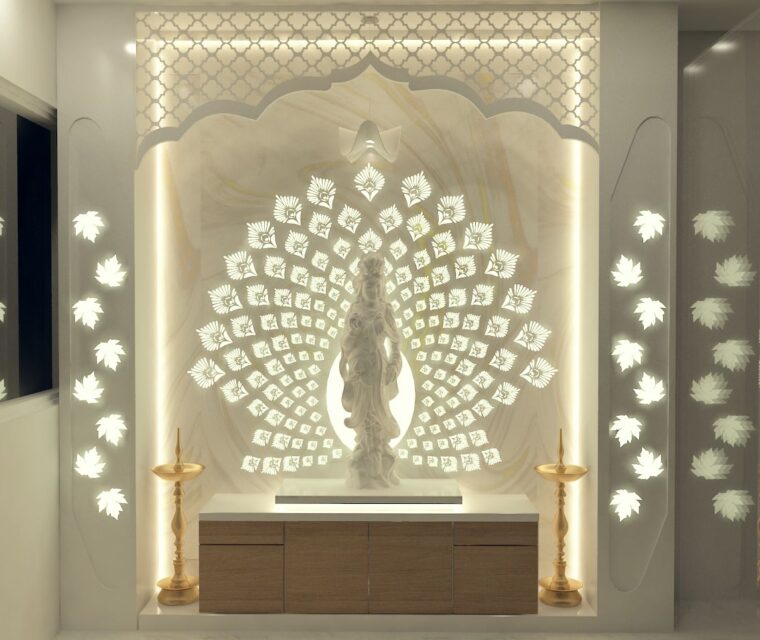 Designer home mandir with marble goddess statue, backlit intricate peacock pattern and brass lamps for puja room