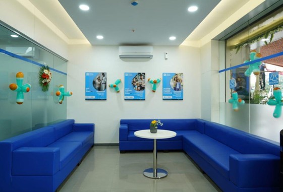 Modern medical clinic reception interior with blue sofas, glass partitions, and ambient lighting – healthcare lounge design inspiration