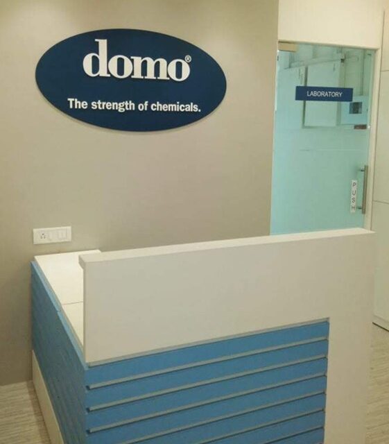 Modern chemical company reception area with domo brand logo – industrial office interiors project